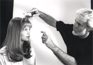 george caroll using the hairflex brush in his salon on client